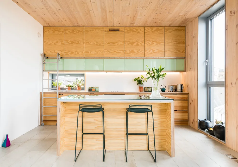 Light plywood dining and kitchen space